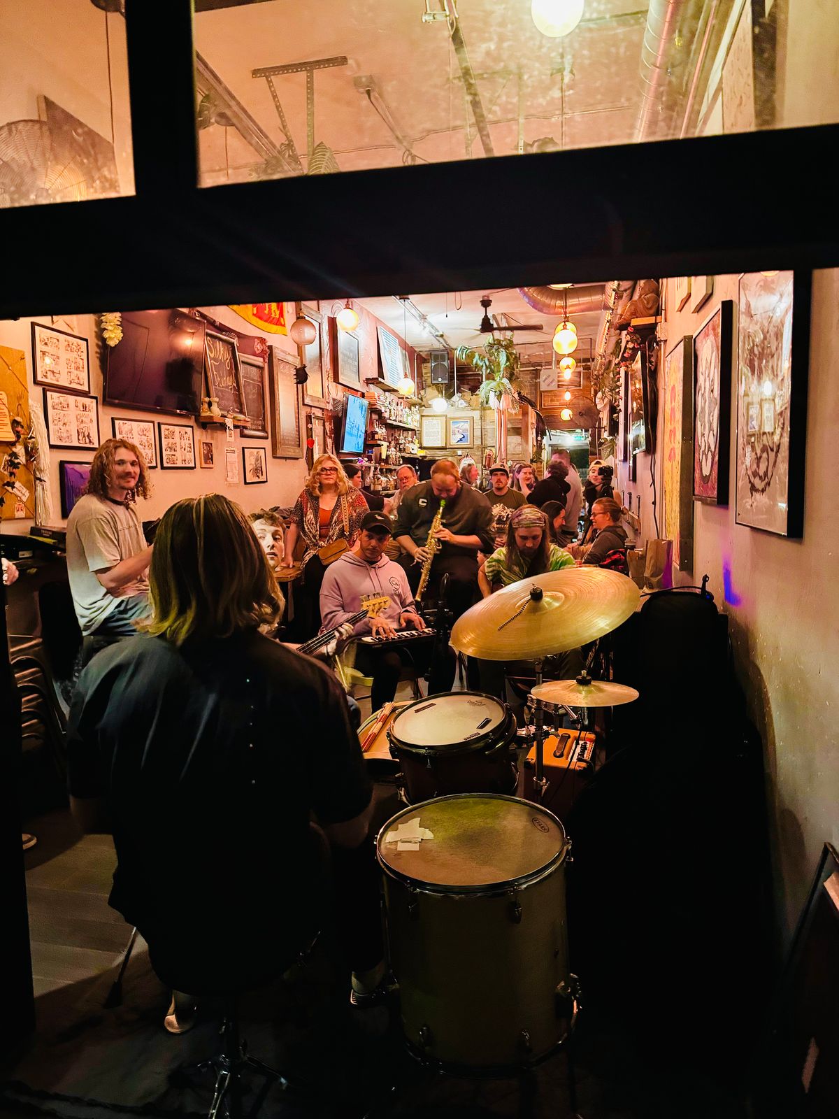 Black Hole Boogie Band recording Protostar at Octave Studios in Boulder — drums in the foreground, horns and listeners behind